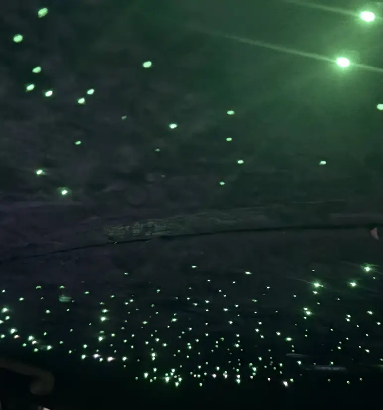 Green fibre optic starlight headliner fitted into a car roof by Rook Auto Customs