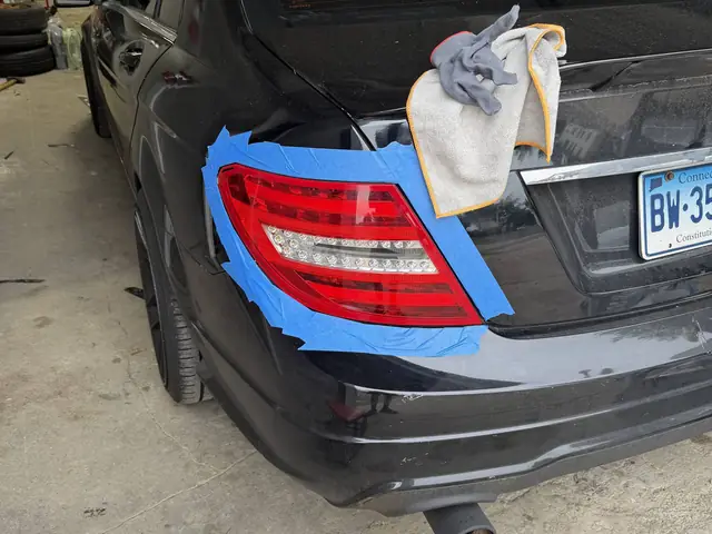 Masking and prep work on a Mercedes C-Class before tail light tinting