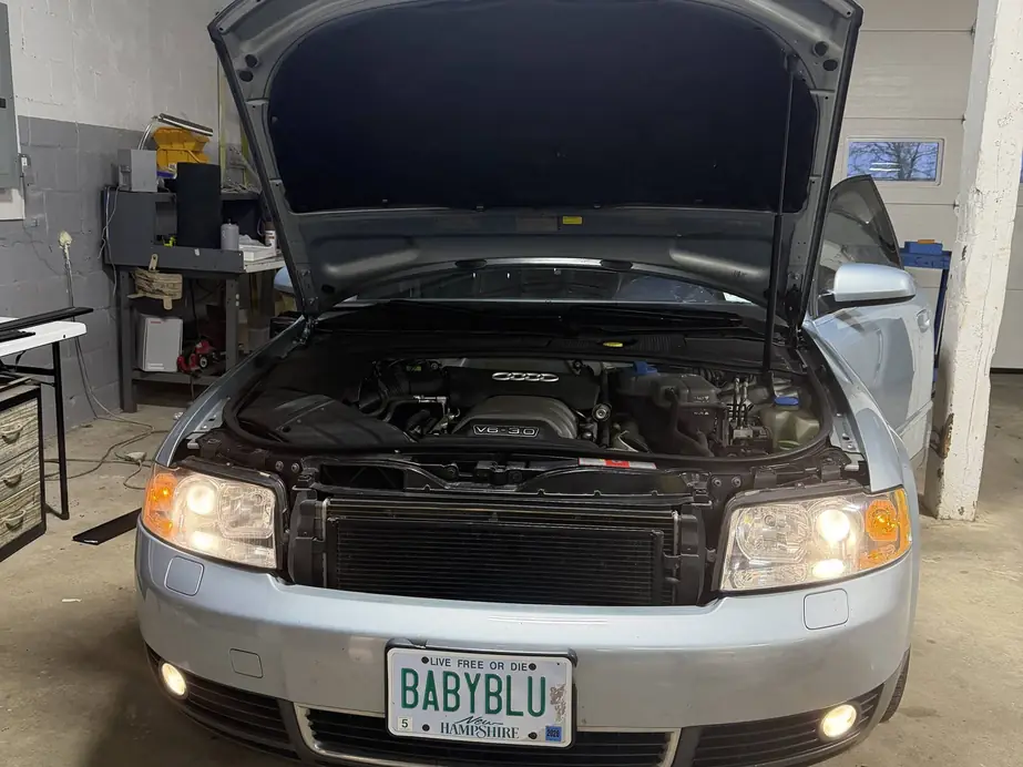 Silver Audi A4 with the hood raised in the Rook Auto Customs shop bay during a diagnostic check