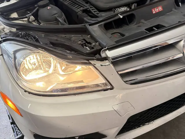 Headlight restoration in progress on a Mercedes