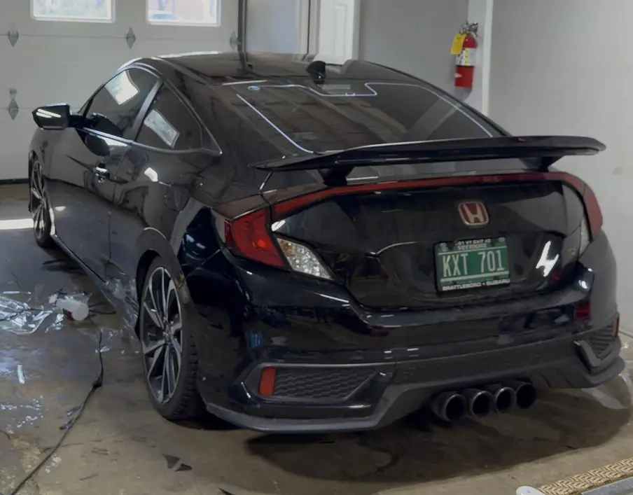 Finished black Honda Civic Si with completed window tint, photographed inside the Rook Auto Customs shop